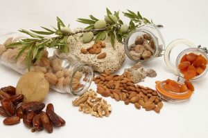 A bunch of different nuts and dried fruits spilled out of jars