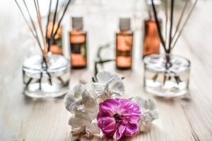 Essential oils with some flowers on the front in a relaxing vibe