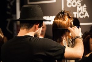Hair stylist brushing a woman's hair