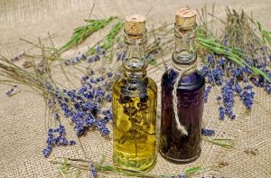 Lavender oil bottles with lavender strings around it