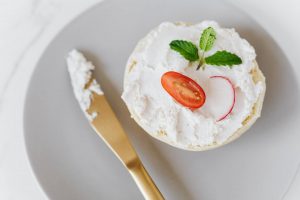 cream spread with vegetables on a piece of bread