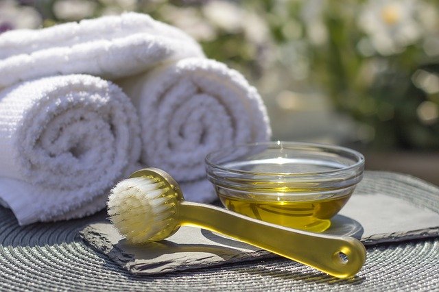 Prickly pear oil in a bowl next to a brush and towels